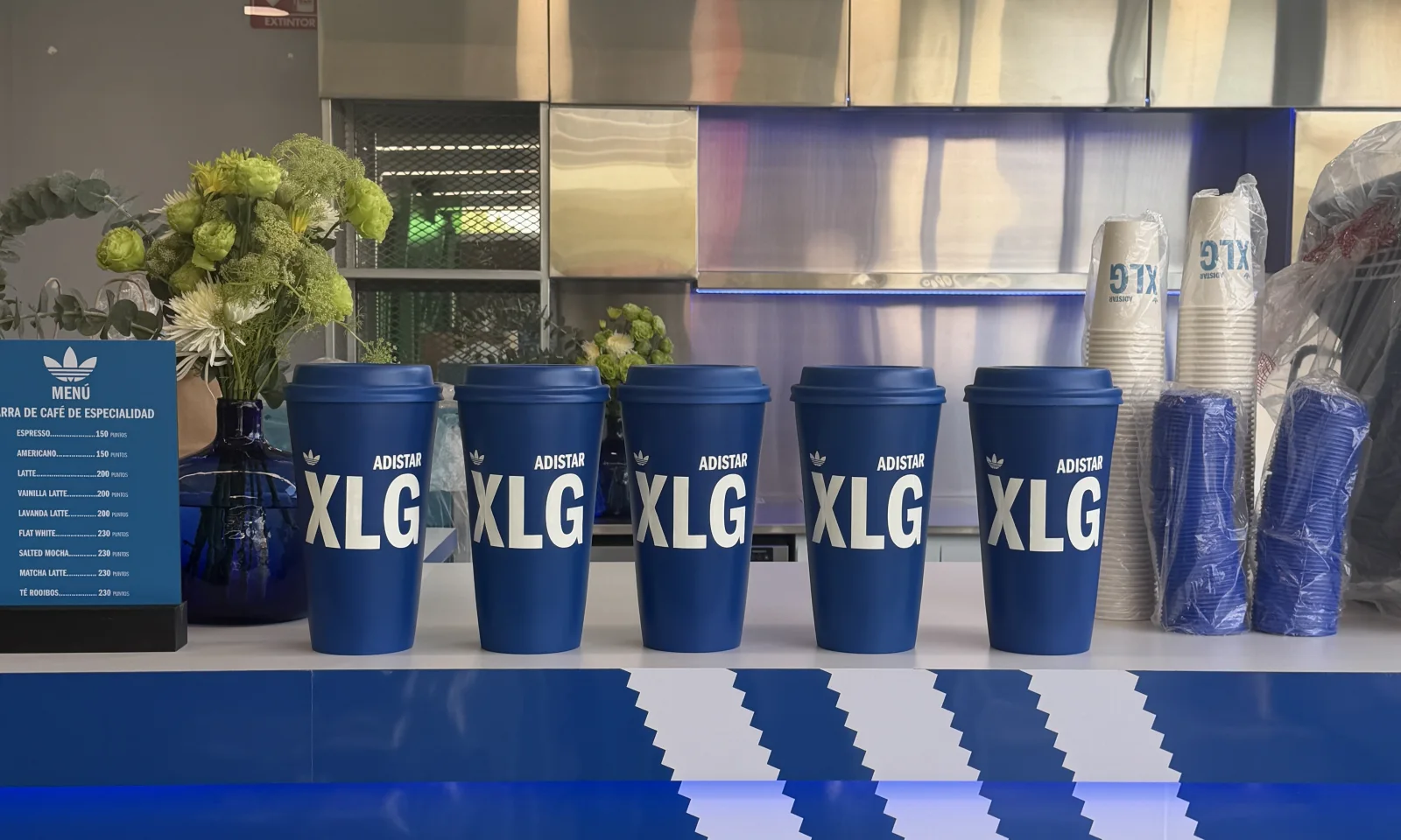 ADIDAS — The ADISTAR XLG coffee bar: the cups in a row and the menu in blue