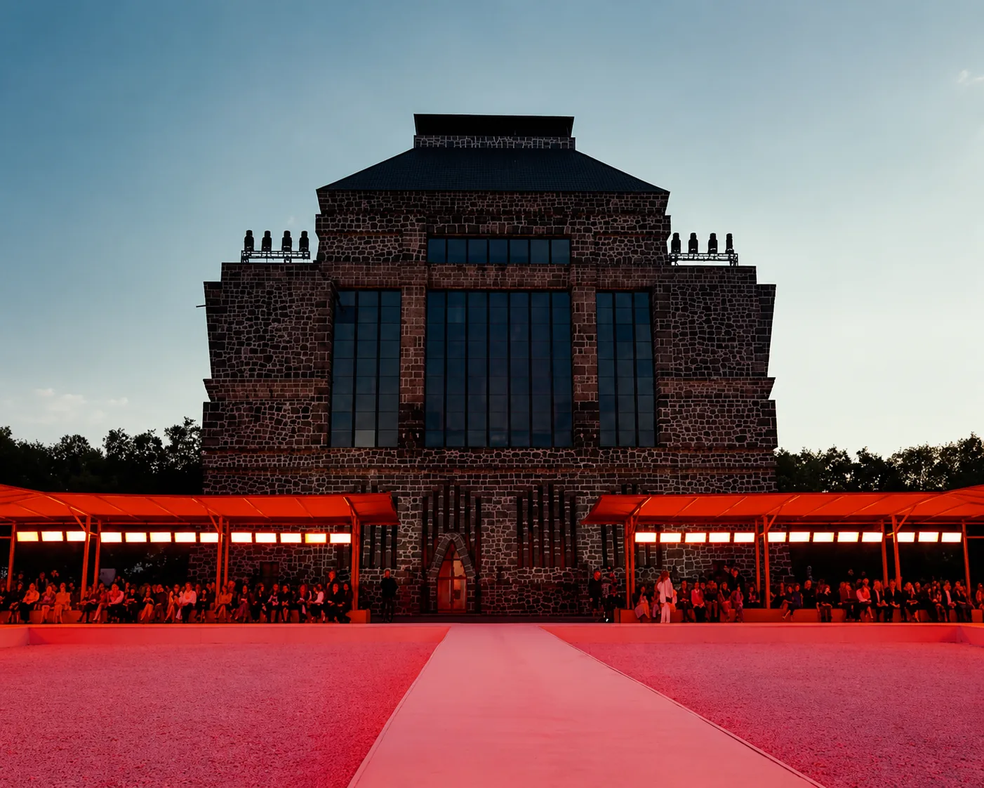 CAROLINA HERRERA — The museum backlit above the red canopies