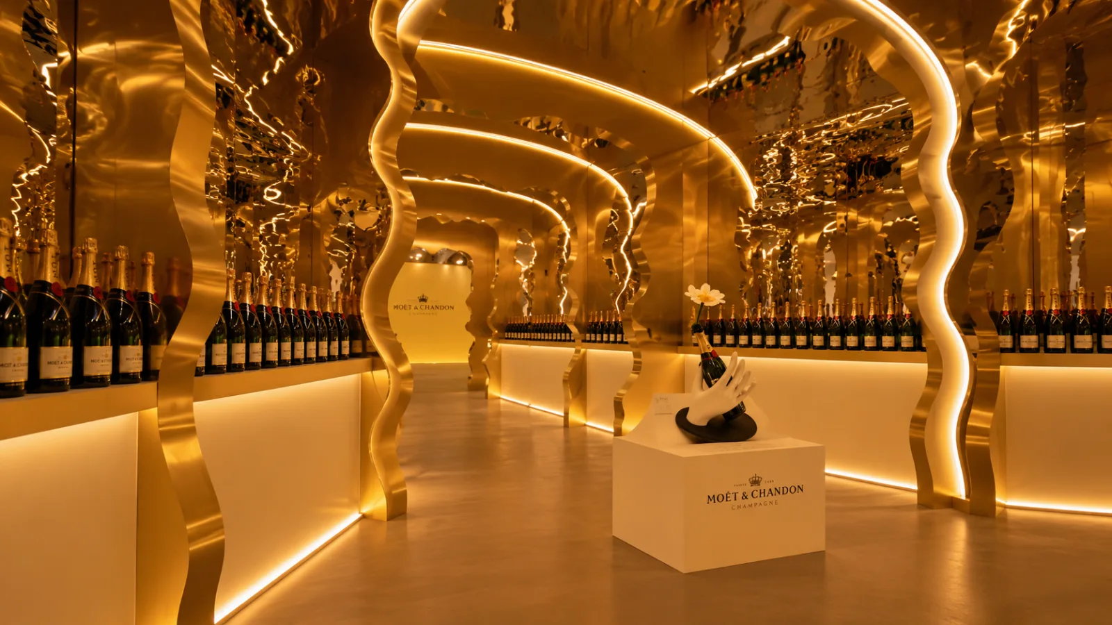 MOËT — The corridor of gilded arches, the porcelain hand on its pedestal