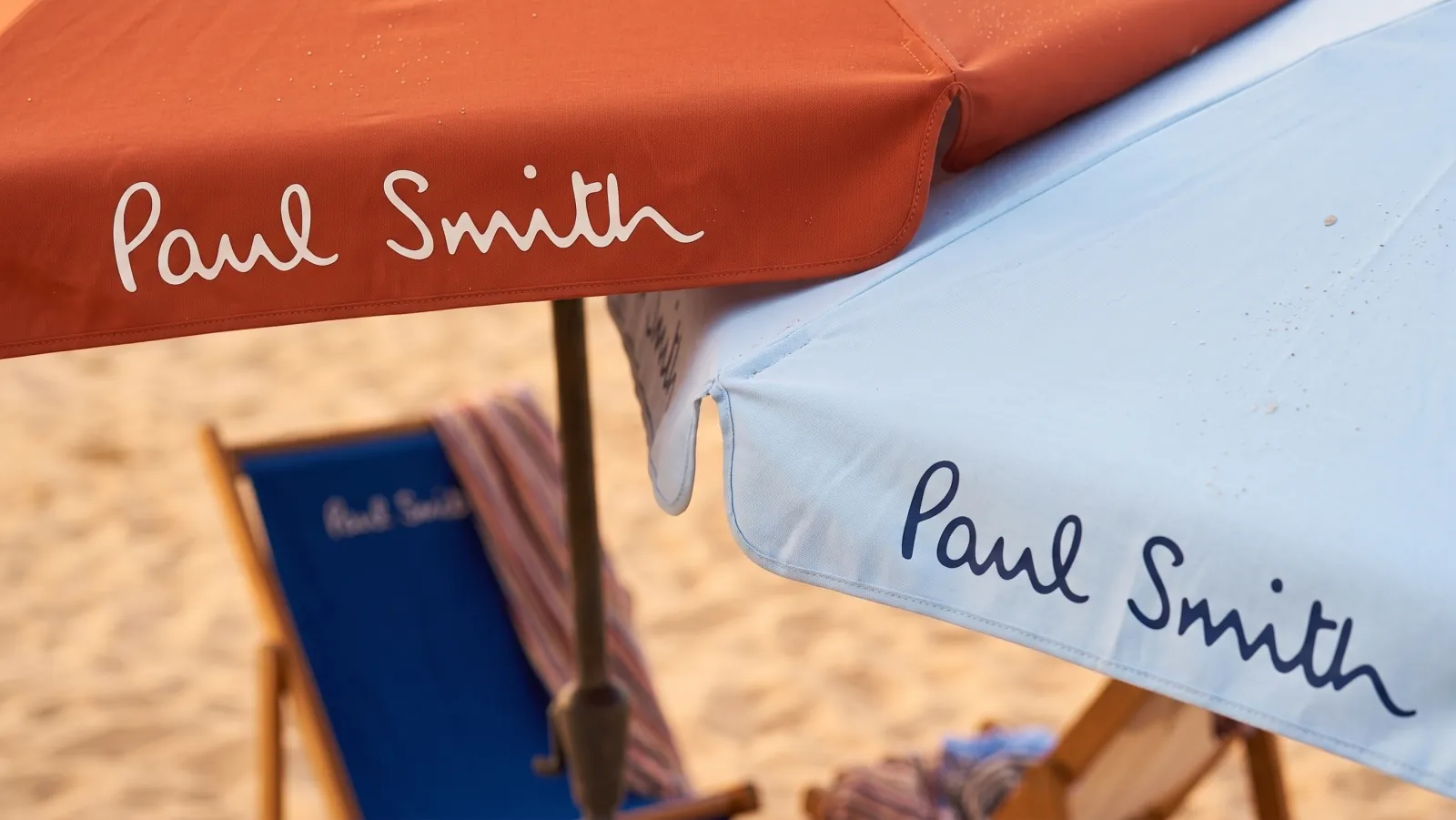 PAUL SMITH — The orange and blue umbrellas, signed, over the sand